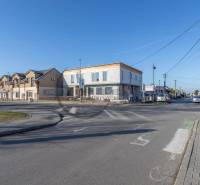 A road and a building in the center of the village Veľké Leváre on a sunny day.