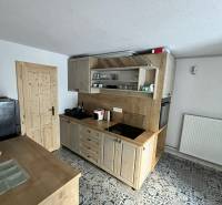 A kitchen in a family house with a kitchen unit, floor with a decorative pattern.