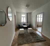 Living room in a family house with a wooden decor floor and comfortable seating.