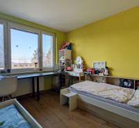 Children's room in a 3-room apartment with a bed, a desk, and a floor with a wooden decor.
