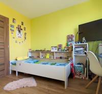 Children's room with furniture and decorations, floor with wooden decor, a pleasant space in a 3-room apartment.
