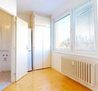 A kitchen with an entrance to the bathroom, a large window, and a radiator, 2-room apartment.
