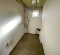 An empty room with a window in a family house, visible installations and preparation for furnishing.