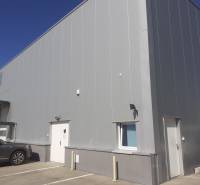 Warehouses and halls on Technická Street in Bratislava-Ružinov, with parked cars in front of the entrance.