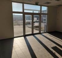 Spacious interior with large windows and tiled flooring in warehouses and halls.