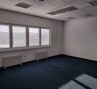 Interiors of warehouses and halls with blue carpet, large windows, and white walls.
