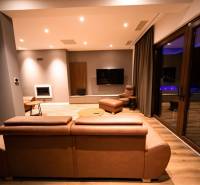 Living room in a villa with a leather sofa and a wooden decor floor.