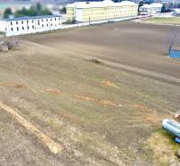 Lands - housing on Kasárenská Street in Sereď with extensive fields and warehouses.