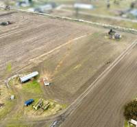 A view of arable fields with agricultural machinery on Kasárenská Street in Sereď, Land - housing.
