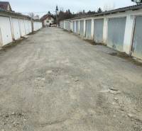 Garages on Urxova Street in Prešov, with a long stone path between them.