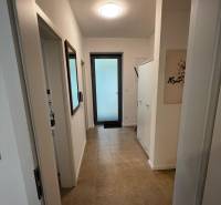 Hallway in a 2-room apartment with ceramic tiles on Brečtanová Street.