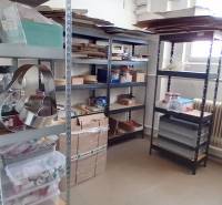 Shelving system with boxes and supplies in warehouses and halls.