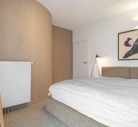 Bedroom in a 4-room apartment, with decorative wallpaper and art on the wall.