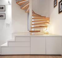 A stylish spiral staircase in a 4-room apartment with a wooden decor floor.
