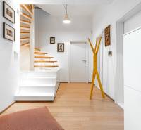 Interior of a 4-room apartment with wood-patterned flooring and open staircases.
