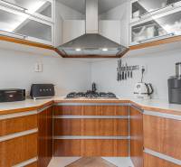 A kitchen in a 4-room apartment with a stainless steel extractor hood and appliances.