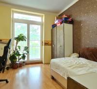 A simple room with a wooden floor and a desk in a two-room apartment.