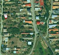 Aerial view of plots - housing in Nováčany with scattered development and greenery.