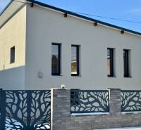 A family house on Gyňovská Street in Čaňa with a modern fence and a flat roof.