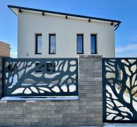 A family house on Gyňovská Street in Čaňa with a modern fence and a simple facade.