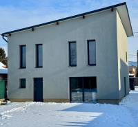 A family house on Gyňovská Street in Čaňa with a snow-covered yard and a minimalist facade.