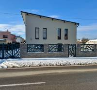 A family house on Gyňovská Street in Čaňa with an interesting fence and a snowy surroundings.