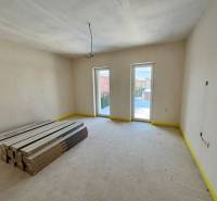 A spacious room in a family house with packages of laminate flooring, ready for installation.