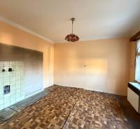 A room with a window, a floor with wood decor, and ceramic tiles, family house.