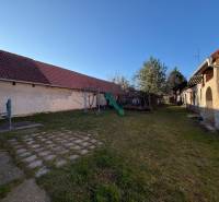 The garden of a family house on Bratislavská Street in Svätý Jur, with a playground and a garden pump.