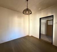 Interior of a family house with a wooden decor floor and a pendant lamp.