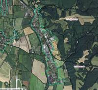 An aerial view of agricultural and forest lands around Badín.