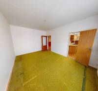 A room with carpet flooring and white walls in a 3-room apartment.