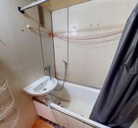 Bathroom in a 3-room apartment with a bathtub, mirror, and curtain.