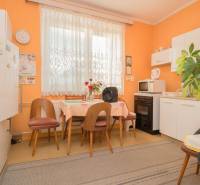 A kitchen with furniture and home accessories in a family house, floor with wooden decor.