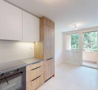A kitchen with a built-in oven and wooden decor doors in a 4-room apartment.