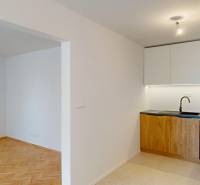 The kitchen in a 4-room apartment with a built-in unit and flooring with a wood decor.