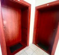 Wooden entrance doors with numbers and light-colored tiles in the offices.