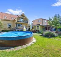 A family house on Tehelná Street in Sereď with a swimming pool and garden seating.