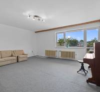 Living room with a sofa and a piano in a family house.
