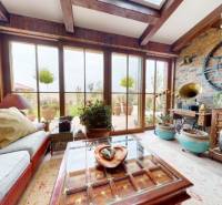 Interior of a family house with historical decorations and large windows, floor with wooden decor.