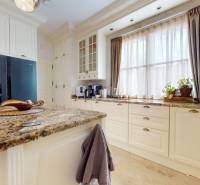 A kitchen in a family house with a granite countertop and large windows.
