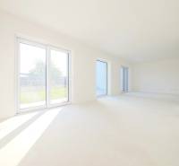 Interior of a family house with large windows and a view of the garden.