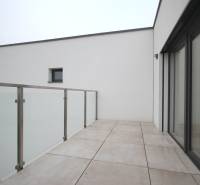 The terrace of a family house on Legionárska Street in Trenčín, with glass railings and paving.