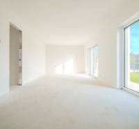 A spacious room in a family house with large windows and a view of the garden.