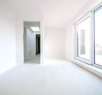 A bright room in a family house with large glass doors leading to the terrace.