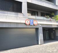 Garages on Jozefská Street in Bratislava - Old Town with warning signs.