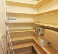 Pantry with shelves and stored items in a 3-room apartment.