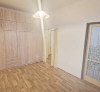 Interior of a 3-room apartment with a wooden decor floor and a built-in wardrobe.