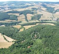 Aerial view of a family house in the village of Vrbovce amidst picturesque nature and fields.