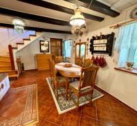 Dining room in a family house with wooden decor, decorated with rustic furniture and details.